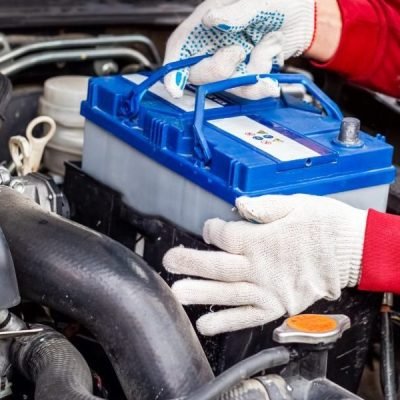Car battery being load-tested with an electronic tester at Auto Car Repair Dubai